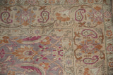 Corner detail of the paisley boteh main border with magenta, sand, and orange floral palmettes.