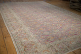 Vintage Kayseri carpet showing the distressed texture and repeating Herati design from a low angle.