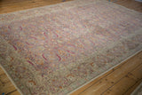 Angled view showcasing the muted color palette and low pile of a distressed Kayseri carpet.
