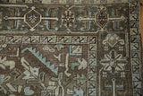 Distressed vintage Heriz rug pile with geometric leaves, palmettes, and border design.