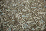 Distressed Heriz carpet: geometric leaves, palmettes, ivory, pale blue, green tones.