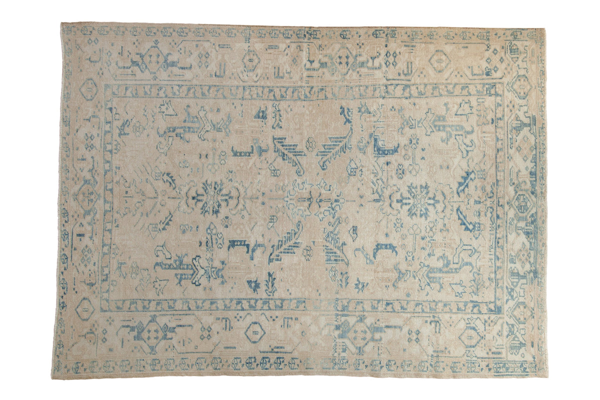 Vintage distressed Ahar carpet with blue floral palmettes and a turtle design border on a sand colored ground.
