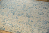 Close perspective on the distressed pile and dusty blue turtle samovar motifs of the vintage Ahar carpet.