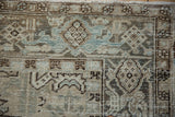 Worn knot heads and the turtle border motif on a vintage Persian carpet.