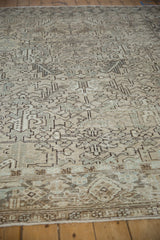 Low angle on the distressed Heriz carpet's texture, with foundation showing through the mostly even wear.