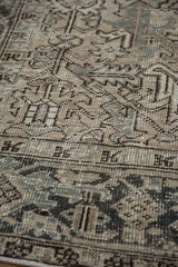 Distressed texture of a vintage Heriz carpet with even wear revealing beige and slate blue knot heads.