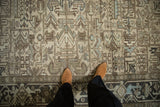 Detail of a distressed Heriz carpet's geometric field and serrated turtle samovar design border.