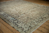 Angled view of a vintage Heriz carpet's low-pile texture and sharp geometric turtle border.