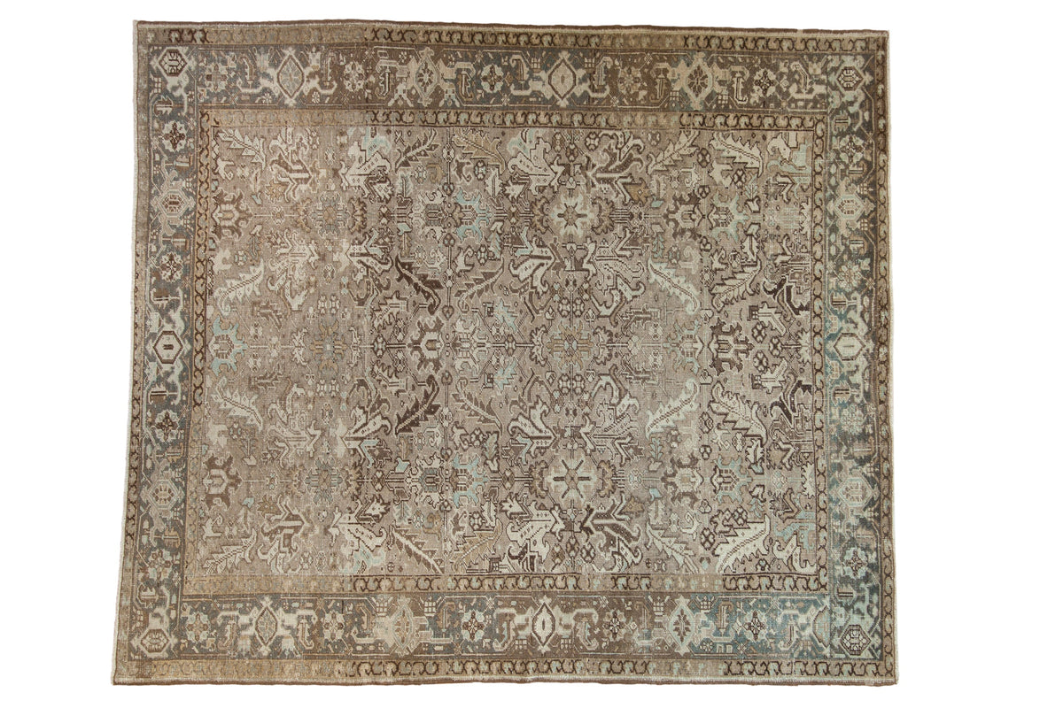 Vintage distressed Heriz carpet with a curvilinear allover design in earthy tones of beige, dusty blue, and chocolate brown.