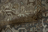 The mostly even wear and hand-knotted texture on the distressed pile of a vintage Heriz.