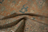 Distressed vintage Kayseri rug showing muted terracotta, teal, and rose floral pattern.