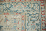 Detail of Heriz carpet border with Herati designs and low, even wear in dusty teal and sand.