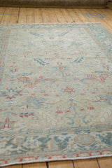 Low-angle perspective showing the distressed texture and low pile of the vintage Heriz carpet.