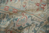 Close-up showing the mostly even wear and hand-knotted texture of a distressed Persian Heriz carpet.