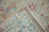 Restored side cord selvage and hand-knotted foundation of a distressed vintage Heriz rug.