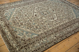 Distressed vintage Hamadan rug corner with ivory and blue Herati field and brown double helix border.
