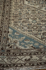 Distressed vintage Hamadan rug pile, even wear, faint foundation, slate blue and brown Herati patterns.
