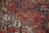 Traditional Heriz carpet's intricate floral cross sections and dragon arabesques in rich jewel tones.