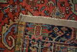 Hand-knotted Heriz carpet's foundation displays intricate weave, vibrant pile, and reinforced edge.