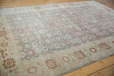 View across the slate blue-green field and ivory border of a vintage Sparta carpet.