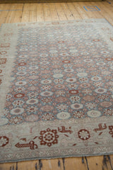 Low-angle view across the repeating floral pattern of a vintage hand-knotted Turkish Sparta carpet.
