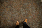 Distressed vintage Kamseh rug showing textured pile, geometric medallions, and rust-silver hues.