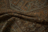 Close-up of the distressed Vintage Kamseh rug's worn pile, featuring muted chestnut, rust, and silver tones.