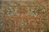 Partial Herati motif in chestnut and dusty teal on a vintage Heriz rug with mostly even wear to knot heads.
