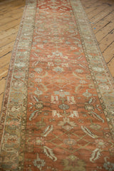 Angled view down the distressed Heriz runner, highlighting its terracotta and teal Herati pattern.