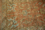 Detail of the Herati motif and worn texture on a vintage Heriz runner in terracotta and teal.
