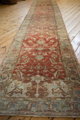 Angled perspective showing the full length of the distressed Heriz runner rug.