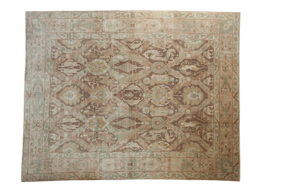 Vintage distressed Sivas carpet with a paneled trellis design of stylized animal figures in pale coffee brown and dusty seafoam green.