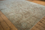 Stylized lion and deer figures within the time-softened paneled design of a vintage Sivas rug.