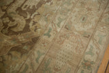 Stylized motifs in the paneled trellis design of a distressed Sivas rug in muted earth tones.