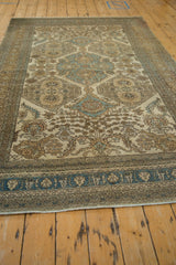 Angled view of the vintage Ardebil carpet showing its low, even pile and full length.
