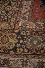 Primitive floral arabesques and palmettes on antique Persian Mahal pile showing subtle wear.