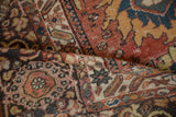 Antique Mahal rug detail with primitive animals, palmettes, and worn pile in madder red, navy, tangerine.