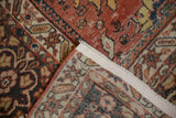 Folded corner of antique Mahal carpet, showing madder red pile, foundation weave, and secured fabric selvage.