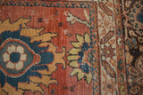Worn antique Mahal rug detail: navy palmette with fiery tangerine outline on madder red, intricate border.