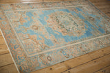 Full-length angled view of a vintage distressed Hamadan rug's soft blue and peach palette.