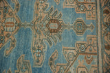 Evenly worn texture of a hand-knotted Hamadan rug showing peach and brown pomegranate design motifs.
