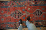 Arrowed and stepped diamond medallions on the madder red ground of an antique Bakshaish runner.