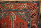 Corner detail of a Persian Bakshaish rug with its serrated leaf border and hand-knotted fringe.