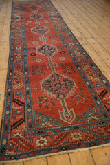 Long perspective on an antique Bakshaish runner showing its column of arrowed, stepped medallions.