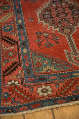 Antique Persian Bakshaish rug corner showing the sky blue serrated leaf border and red field.
