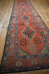 Antique Bakshaish runner viewed from an angle showing its column of geometric medallions.