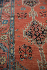 Detailed view of an antique Bakshaish rug's serrated leaf border and stepped geometric medallion.