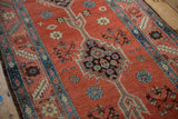 Close view of the antique Bakshaish runner's geometric medallion and serrated leaf border.