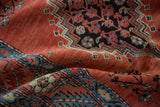 Hand-knotted texture of an antique Bakshaish rug showing serrated medallions and floral motifs.