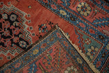 Antique Bakshaish runner corner showing the secured side cord selvage and hand-knotted fringe.